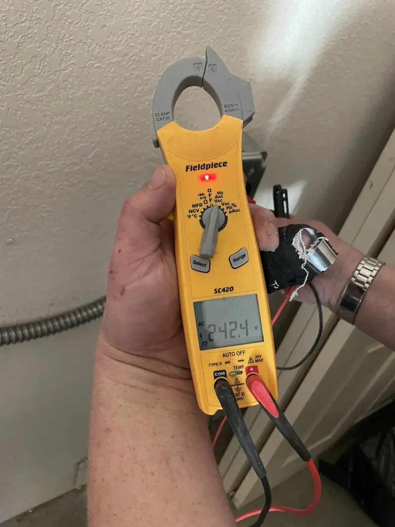 Voltage testing with clamp meter during Ceiling Fan Installation in St. Stephens